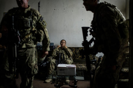 During a nighttime mission, a US Army Sergeant assigned to the 49th Military Police Brigade takes one last moment of rest before setting out back to the base. This mission consisted of meeting with the local Afghan National Police Chief about increased risks in his area, and what the ISAF can do about it. The box on the table contained police notebooks, radios, and other essential items that the US Armys Military Police were providing to the Police Chief.
Published by National Geographic.