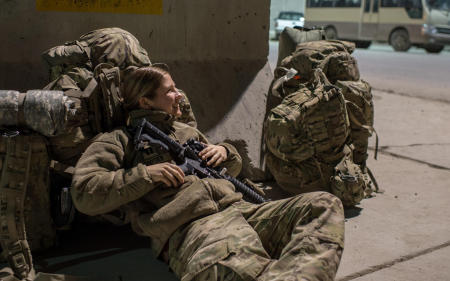 US Army Captain Julie Snyder of the 212 Infantry awaits an available seat on a flight from Bagram Airfield, Afghanistan. 
Published by National Geographic.