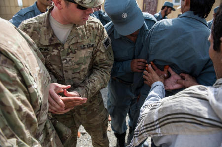 Soldiers from the U.S. Armys 1st Infantry Division, with aid of an interpreter, demonstrate methods for controlling a suspect to officers of the Afghan National Police.
Published by Business Insider.