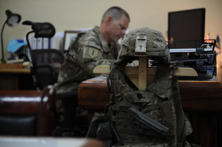 A U.S. Navy Commander works on mission planning in his office at Salerno. Due to the constant threat of incoming rounds, the Commanders armor is stored within reach.
Published by Business Insider.