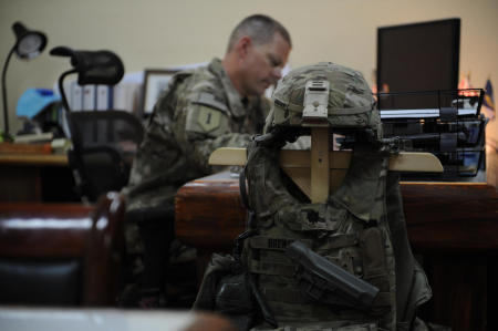 A U.S. Navy Commander works on mission planning in his office at Salerno. Due to the constant threat of incoming rounds, the Commanders armor is stored within reach.
Published by Business Insider.